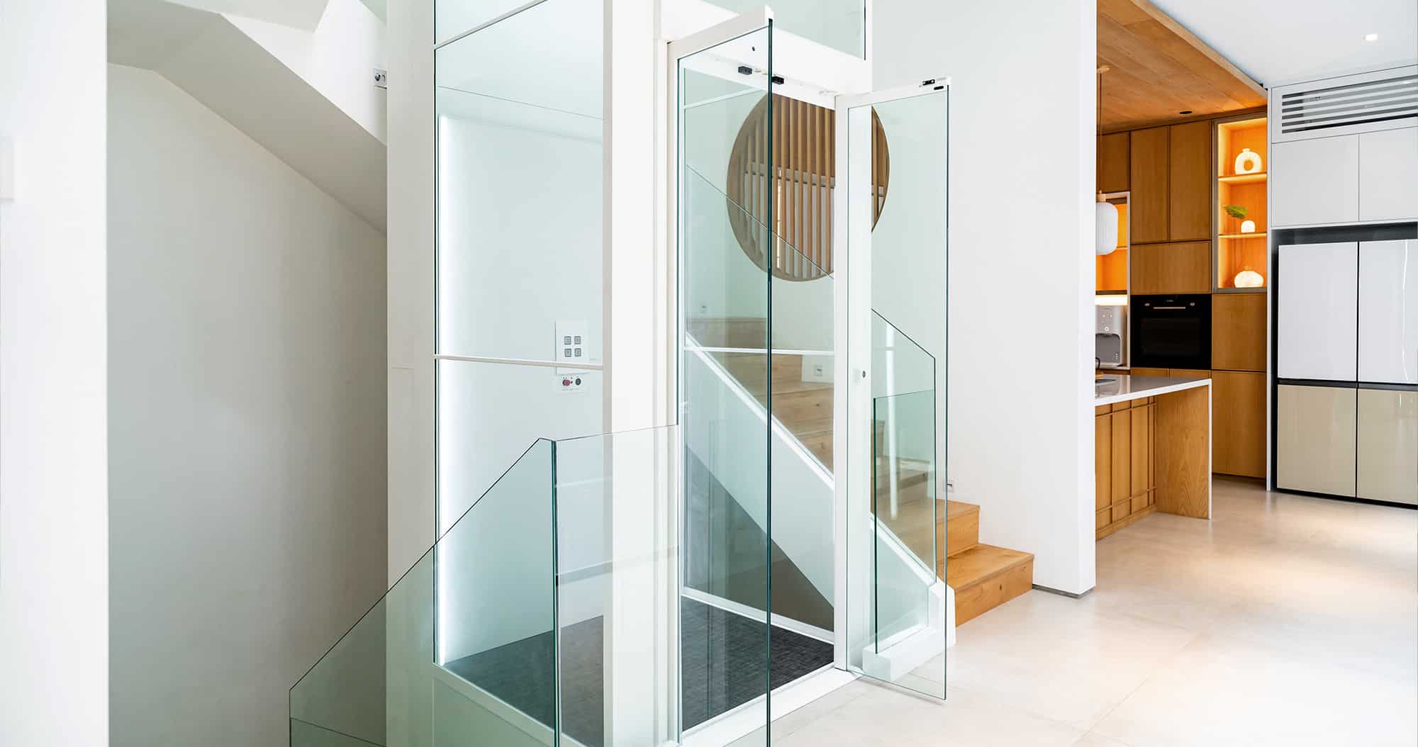 Swift Lite with its glass door open, tucked beside the stairs next to an open kitchen