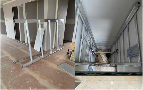 Lift shaft panels and frame sections laid out inside a house, ready to stand
