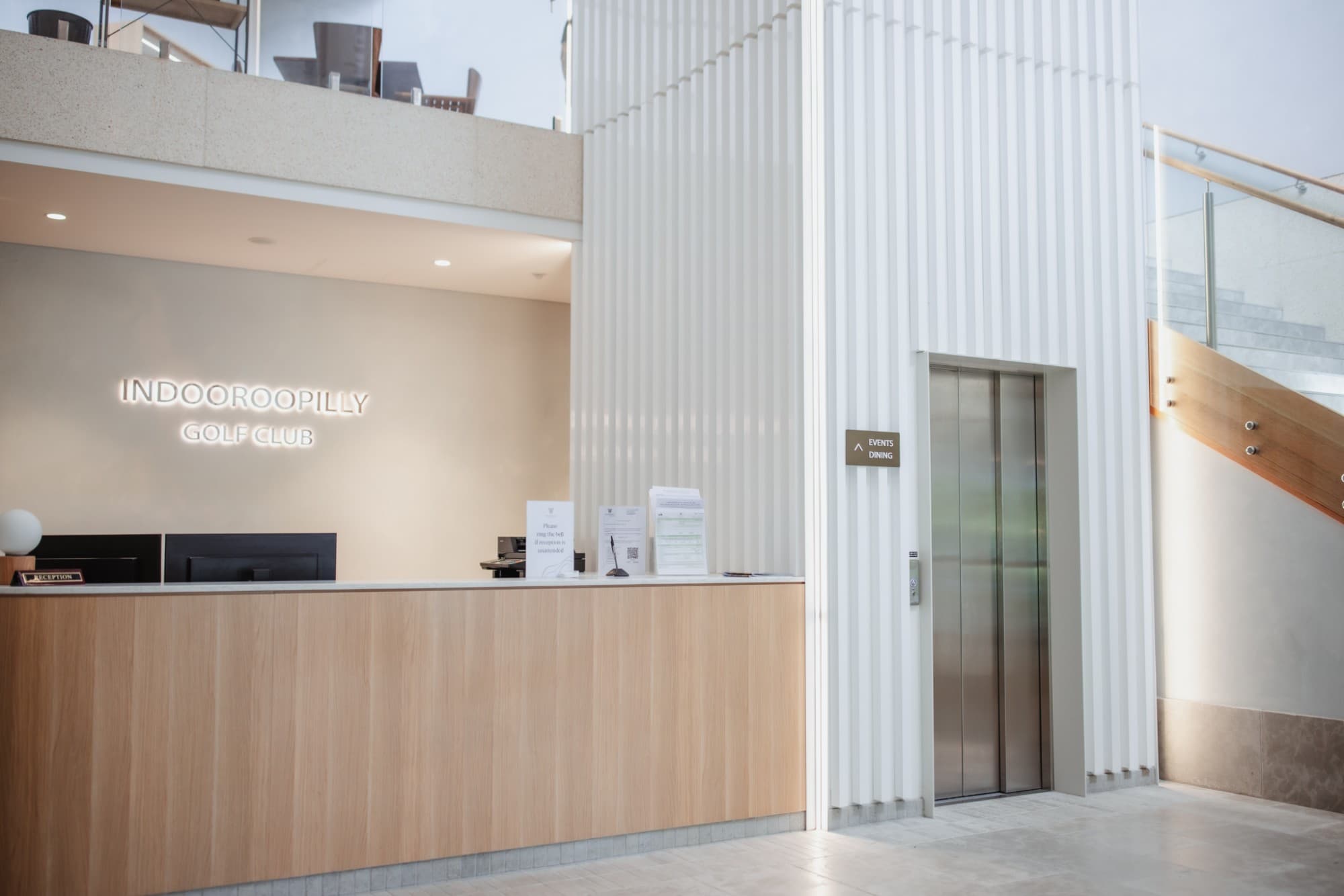 Lift doors beside the reception desk in the foyer at Indooroopilly Golf Club
