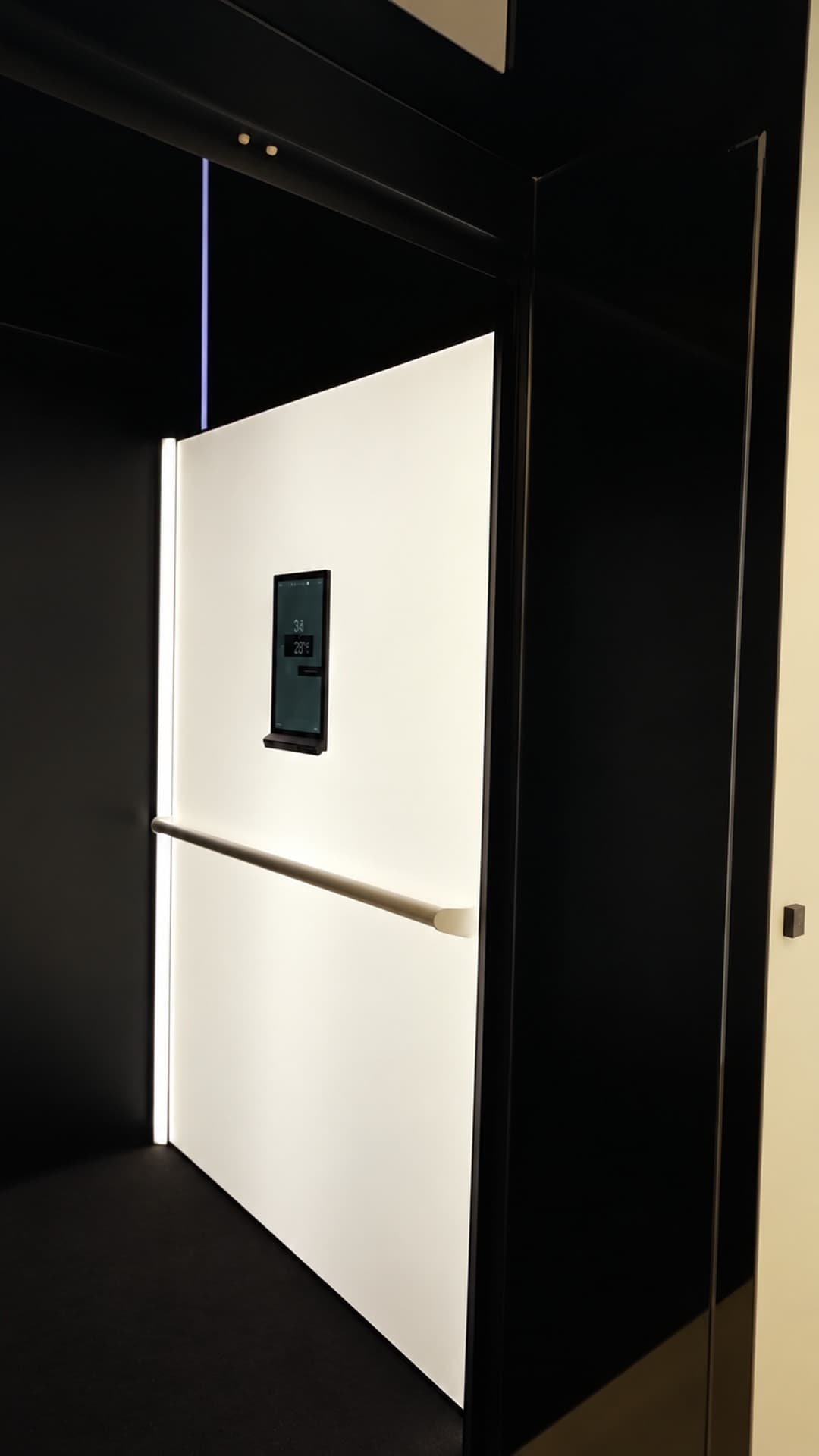 Looking into a Swift Pro XL cabin with Electric Opal white wall, white handrail and Stitch Black floor in a Jet Black shaft in a Broadbeach penthouse