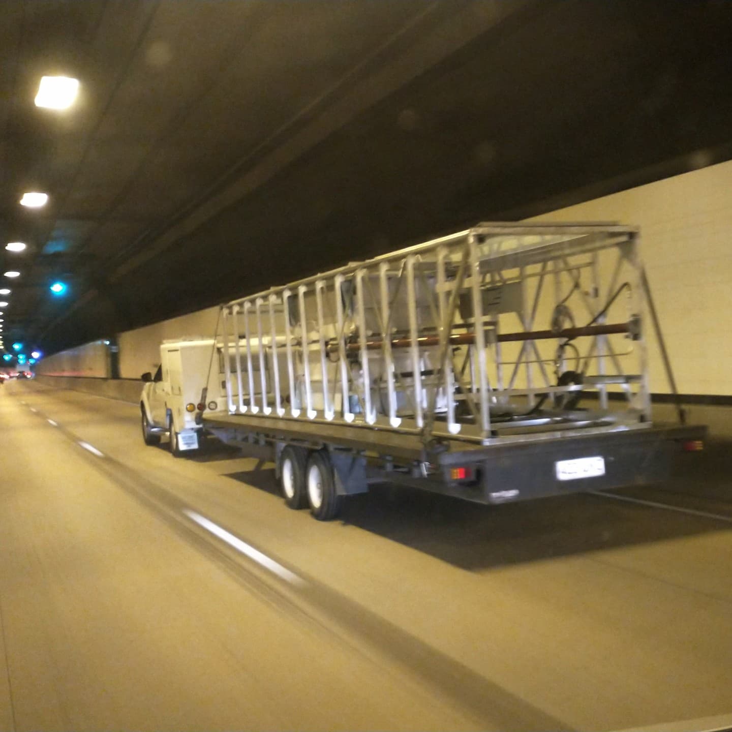 Aussie Lifts ute and trailer delivering a Phoenix home lift shaft and components through a road tunnel bound for a Bundaberg, Queensland home