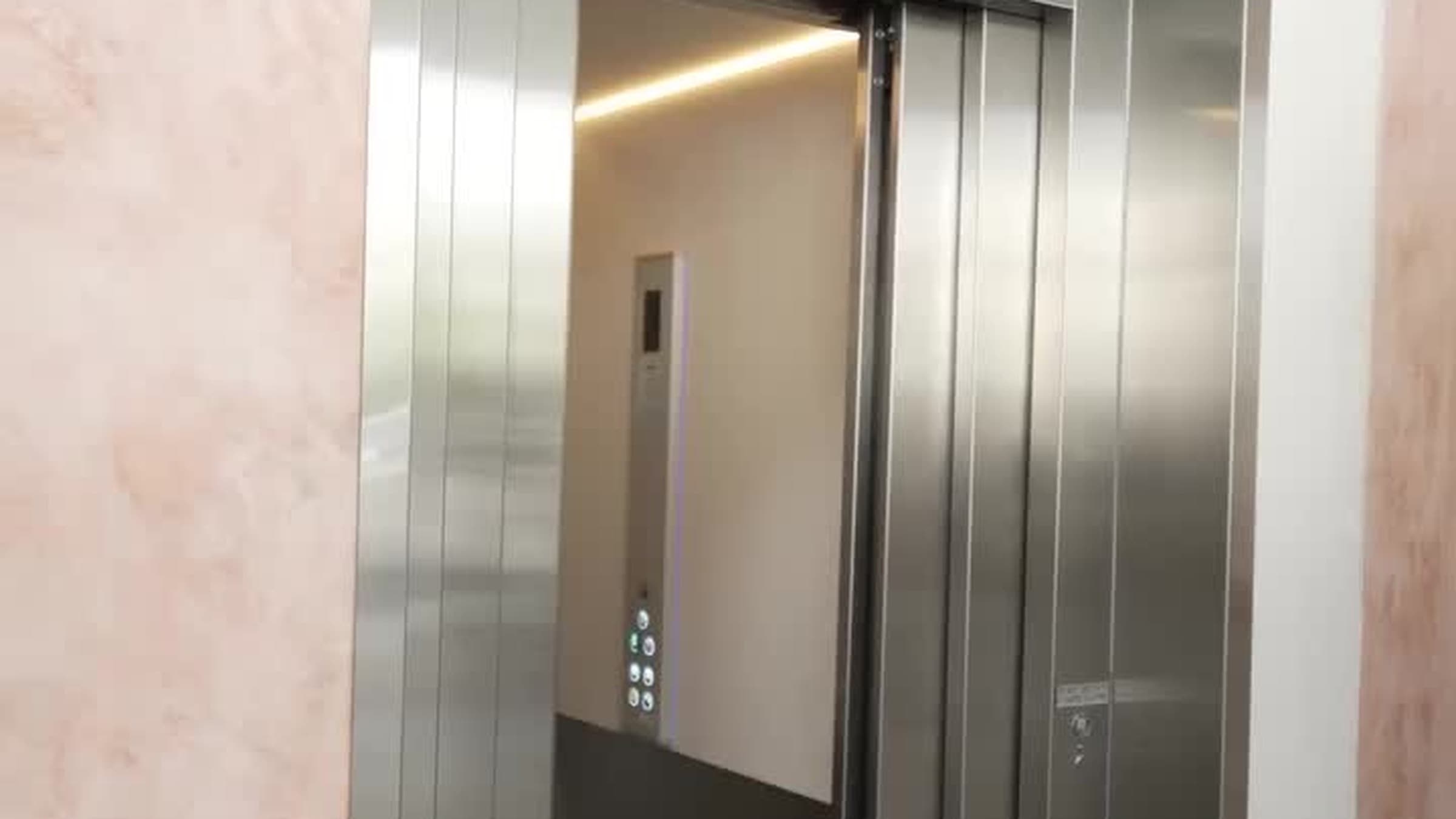 Custom Orion commercial lift with brushed stainless doors fully open at Burleigh Pavilion, Gold Coast, showing the cabin interior and control panel