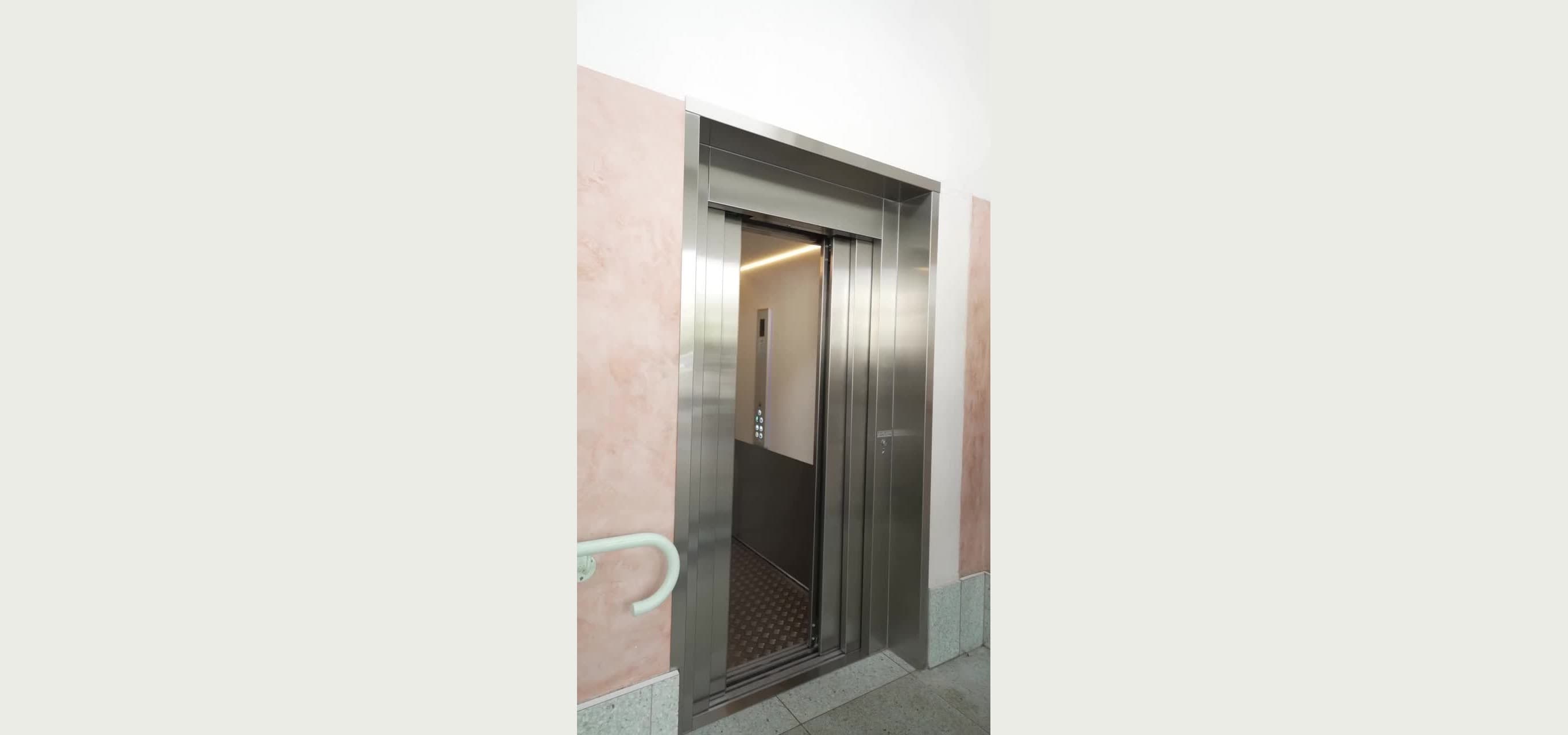 Custom Orion commercial lift with brushed stainless doors fully open at Burleigh Pavilion, Gold Coast, showing the cabin interior and control panel