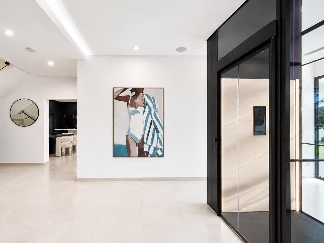 Swift Pro lift car with Concrete Artwall, Stitch Black floor and warm side lighting in a Fannie Bay, Darwin hallway