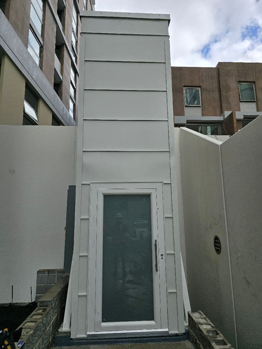 Finished outdoor lift shaft with glass landing door, Macquarie Park, Sydney