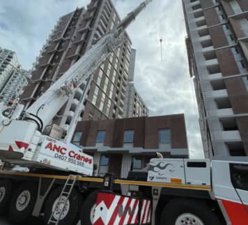 ANC Cranes mobile crane set up between residential towers to crane a Phoenix lift into a Macquarie Park, Sydney development