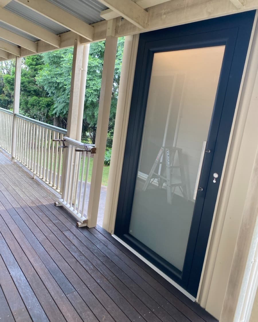 A Phoenix home lift in a Mt Tamborine, Queensland home, upper veranda landing door with frosted glass