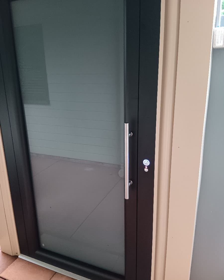 A Phoenix home lift in a Mt Tamborine, Queensland home, frosted glass landing door and blue A call button
