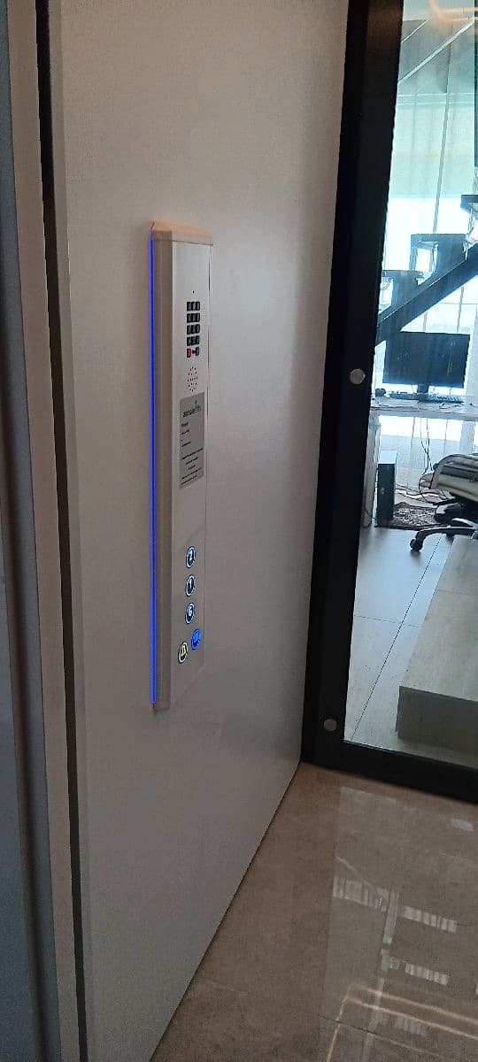 Phoenix home lift call panel with blue LED edge lighting in a Sunrise Beach home, Sunshine Coast