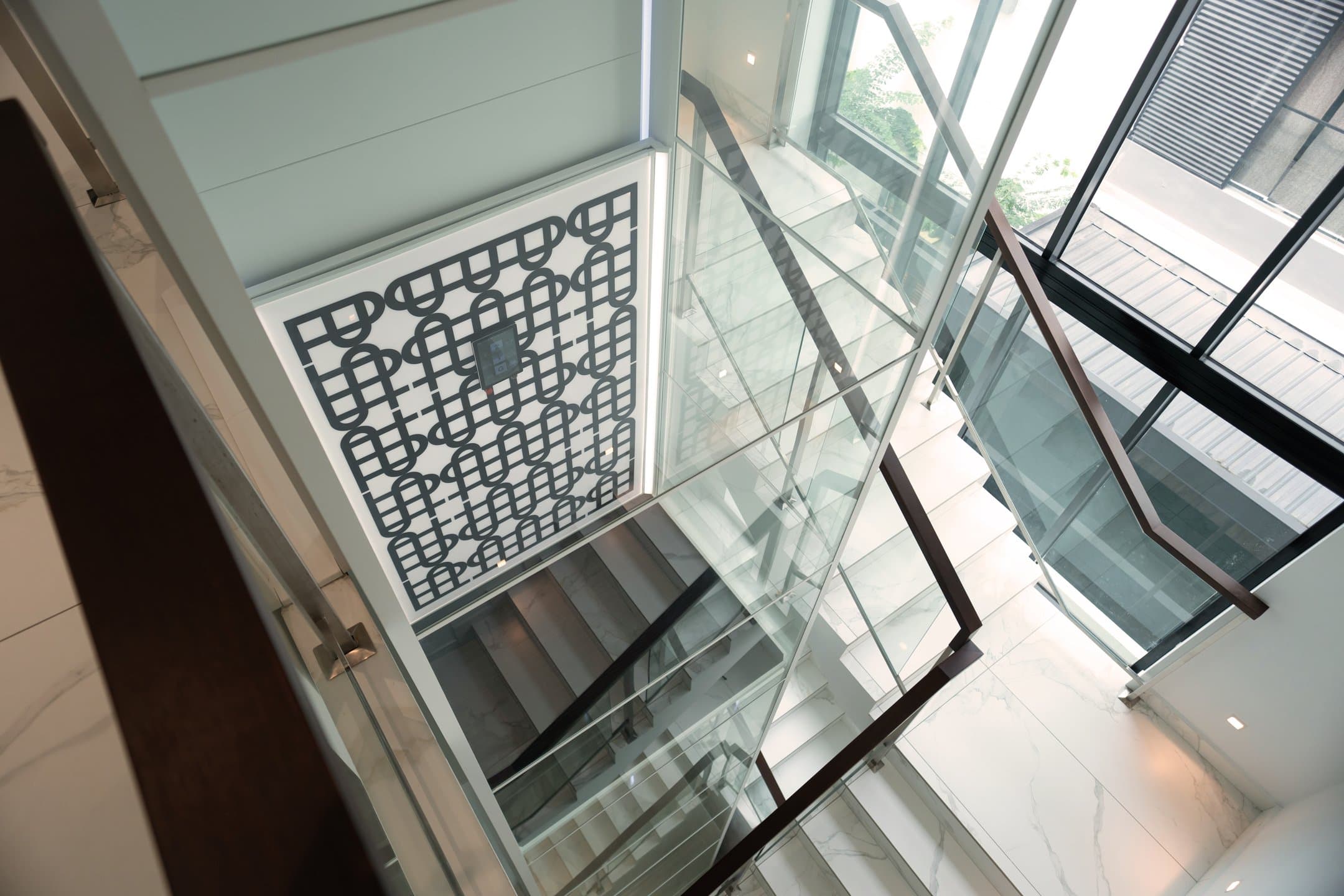 Looking down a glazed Swift Pro shaft alongside a marble staircase